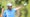 scottie scheffler points fore at the u.s. open in blue shirt and white hat